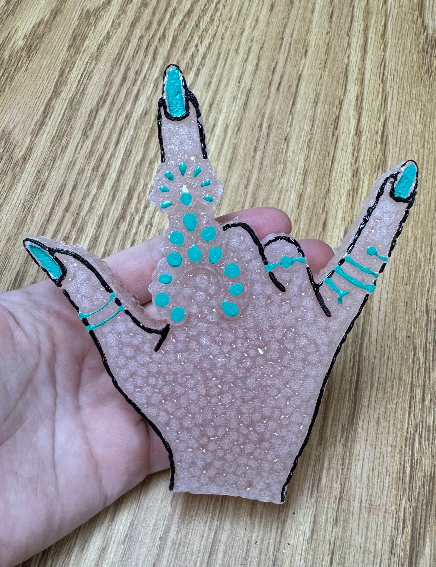 Hand with turquoise Freshie-Mama Tried